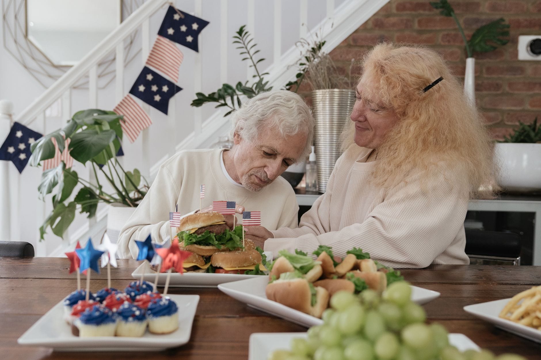 Senior couple enjoying a festive meal indoors on Independence Day.